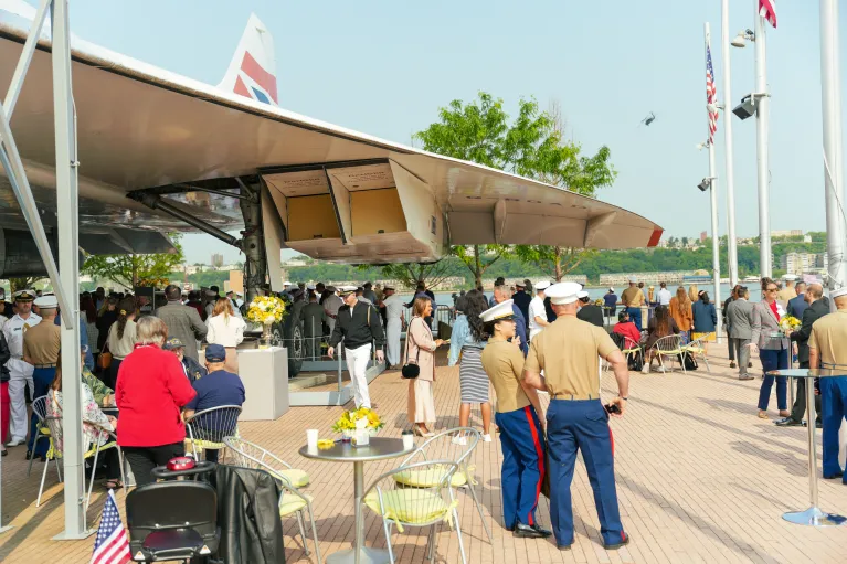 Guests mingle during a summer cocktail reception in the Concorde Plaza